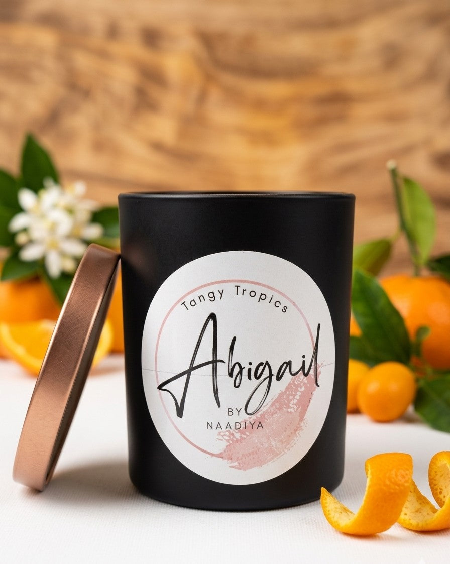 Tangy Tropics citrus candle in bright setting with fresh orange tones